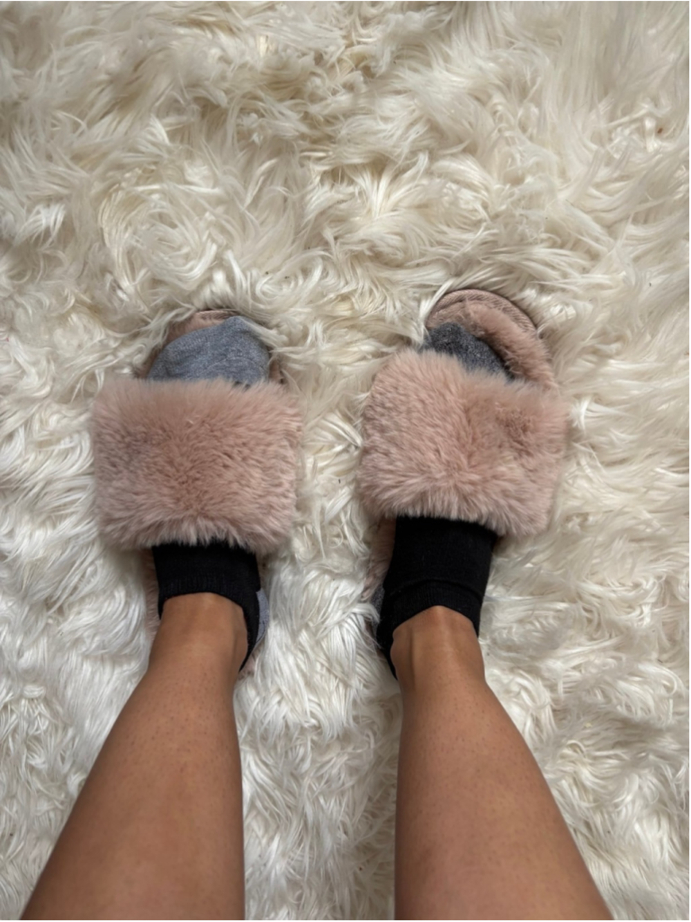 Well worn woman's pink fuzzy house slippers